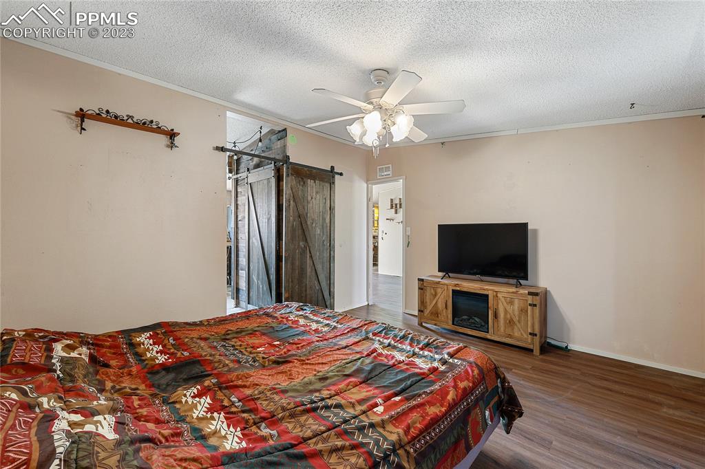 31995 North Neely Road Yoder, CO 80864 - Photo 23 of 46 a bedroom with a bed and a flat screen tv