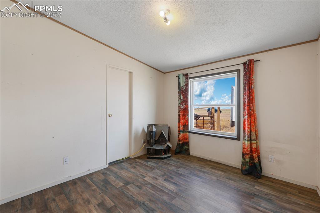 31995 North Neely Road Yoder, CO 80864 - Photo 30 of 46 a room with wooden floor and windows
