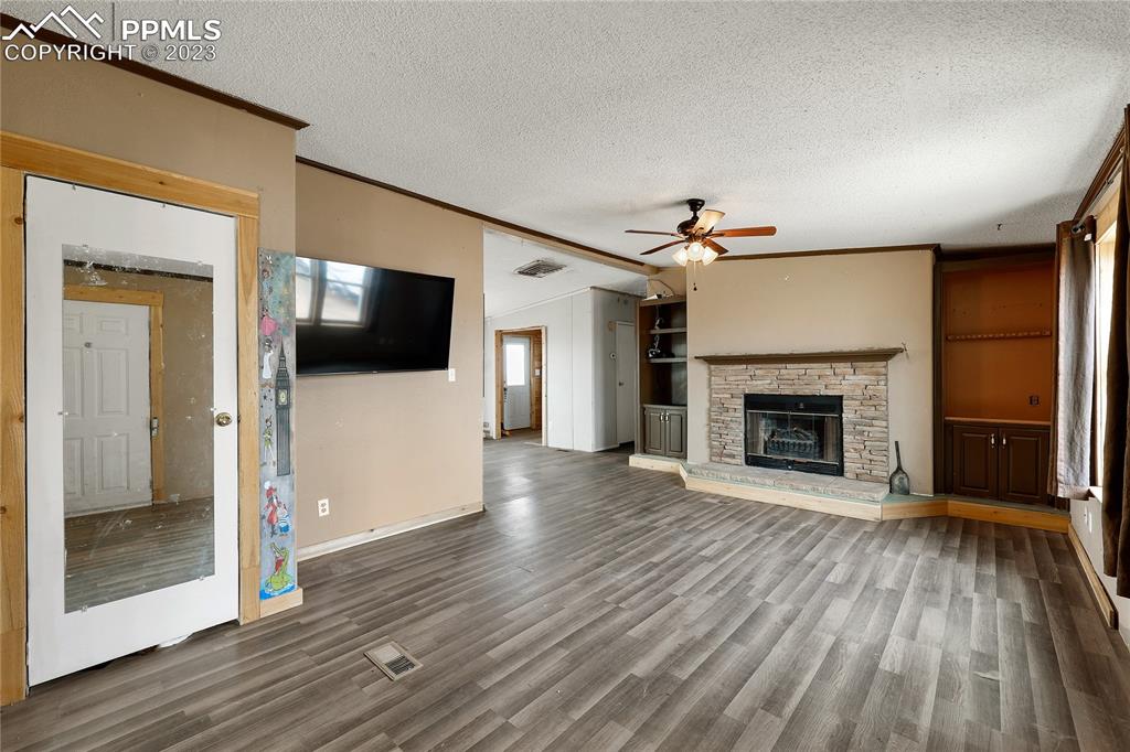 31995 North Neely Road Yoder, CO 80864 - Photo 4 of 46 a view of a livingroom with wooden floor and a fireplace