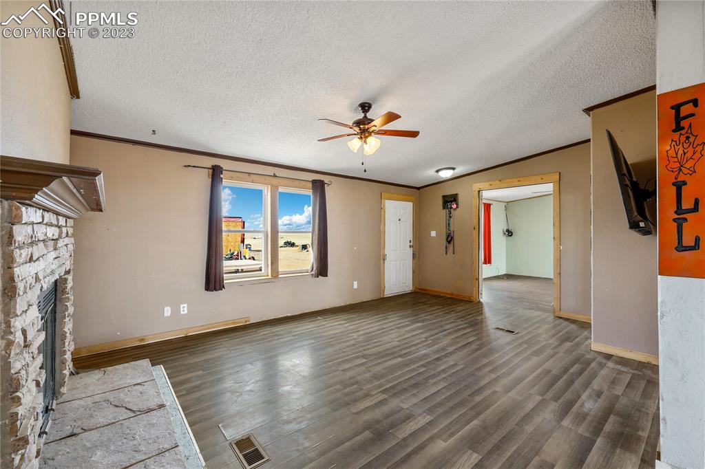 31995 North Neely Road Yoder, CO 80864 - Photo 6 of 46 a view of an empty room with a fireplace and a window