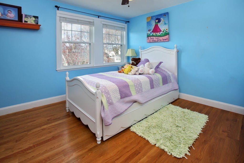 55 Bay State Road Arlington, MA 02474 - Photo 11 of 20 a bedroom with a bed and wooden floor