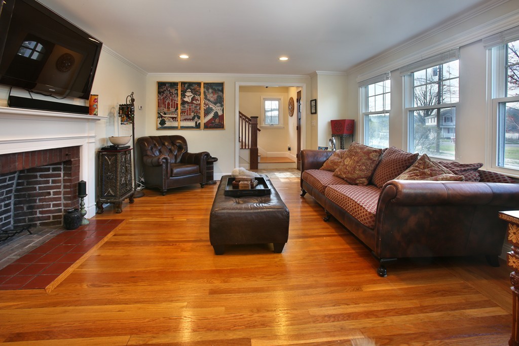 55 Bay State Road Arlington, MA 02474 - Photo 3 of 20 a living room with furniture a flat screen tv and a fireplace