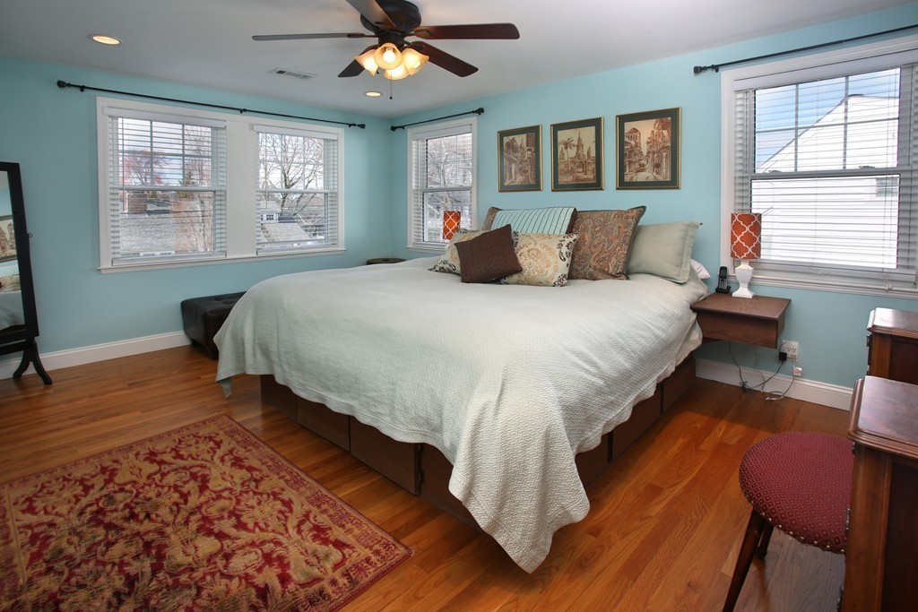 55 Bay State Road Arlington, MA 02474 - Photo 6 of 20 a bedroom with a bed and wooden floor