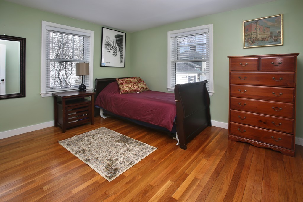 55 Bay State Road Arlington, MA 02474 - Photo 8 of 20 a bedroom with a bed dresser and wooden floor