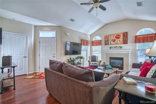 a living room with furniture and a fireplace