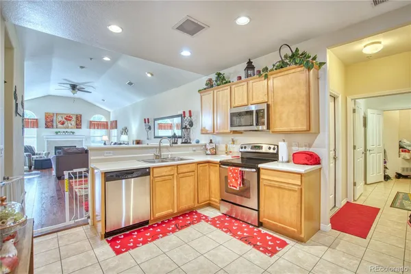 a open kitchen with stainless steel appliances kitchen island granite countertop a stove and cabinets