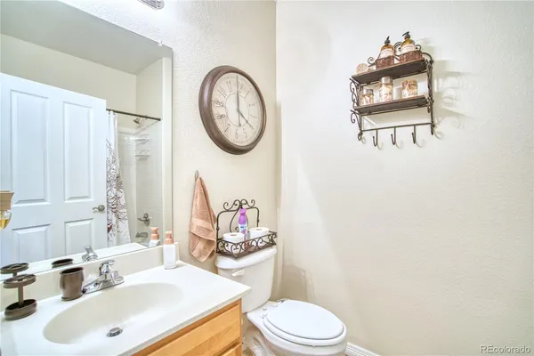 a bathroom with a sink mirror vanity and toilet