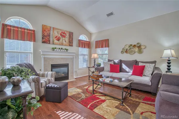 a living room with furniture fireplace and a potted plant