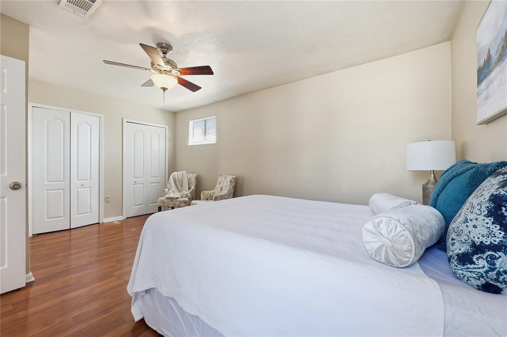 4427 Southwest 21st Lane Gainesville, FL 32607 - Photo 15 of 36 a bedroom with a bed and wooden floor