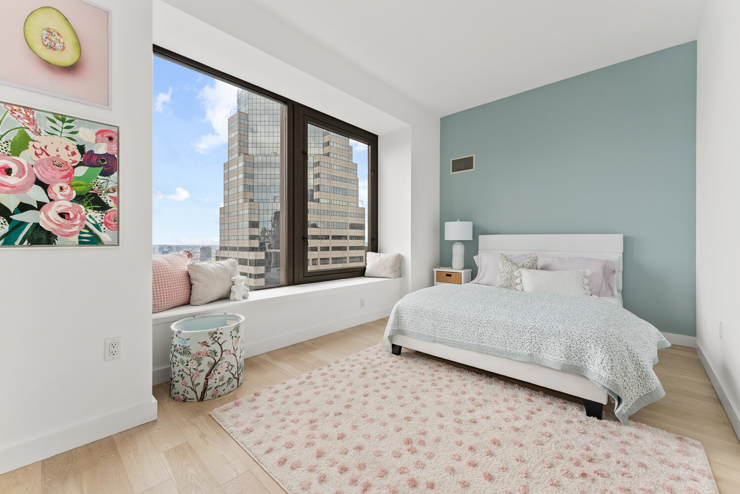 75 Wall Street, Unit 34C Manhattan, NY 10005 - Photo 10 of 26 a bedroom with a bed painting on wall and a large window