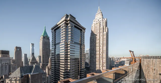 a dining hall with stainless steel appliances granite countertop a stove and chairs with wooden floor