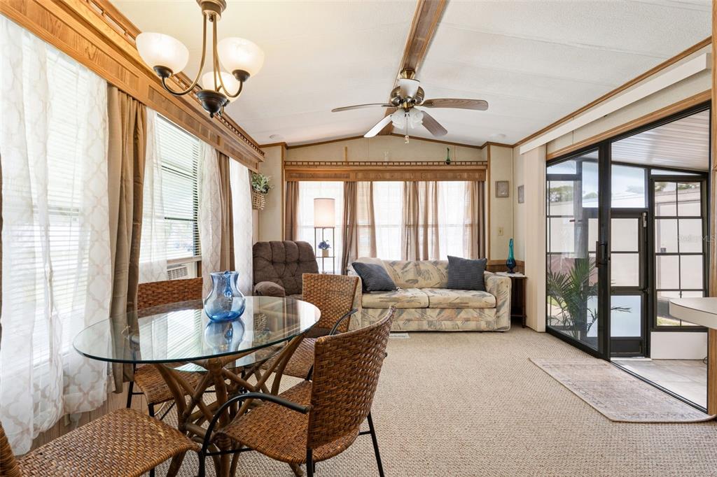 1703 North Manatee Loop Punta Gorda, FL 33950 - Photo 2 of 21 a living room with furniture a chandelier and a dining table