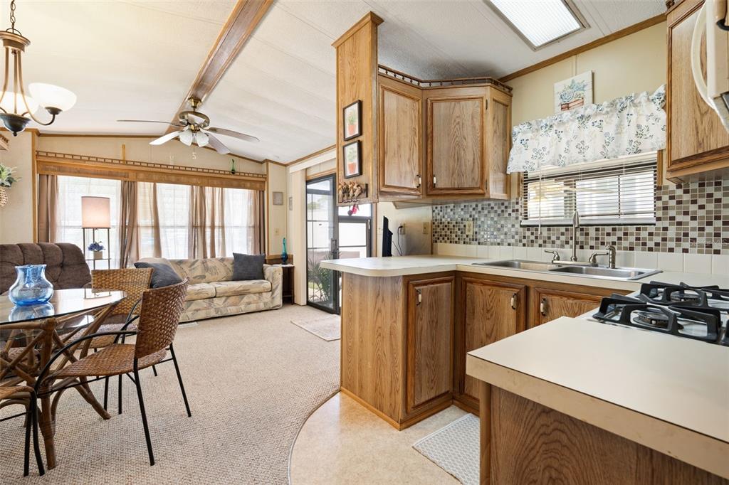 1703 North Manatee Loop Punta Gorda, FL 33950 - Photo 3 of 21 a kitchen with a sink a stove and chairs