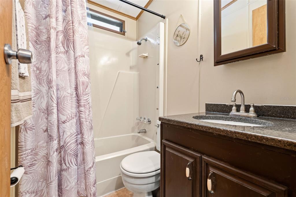1703 North Manatee Loop Punta Gorda, FL 33950 - Photo 9 of 21 a bathroom with a granite countertop sink toilet and shower