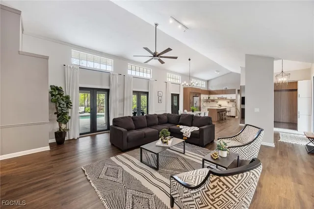 a living room with furniture and a chandelier