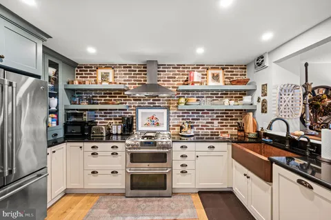 a kitchen with stainless steel appliances a refrigerator sink and stove
