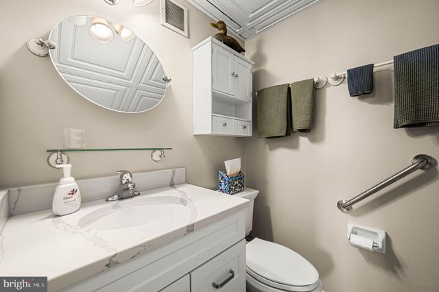 a bathroom with a sink a toilet and a mirror