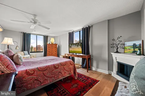 a bedroom with a bed a fireplace and a chandelier