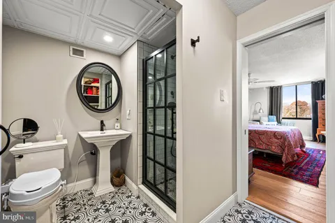 a bathroom with a toilet a sink and a mirror