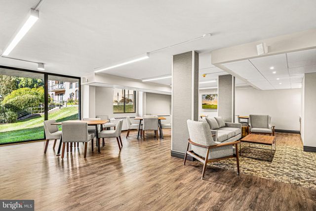 a living room with furniture a table and a large window