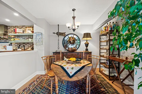 a living room with a clock on a table and a bookshelf