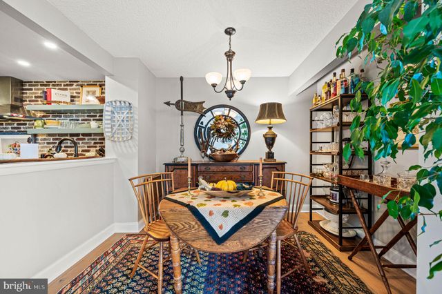 a living room with a clock on a table and a bookshelf