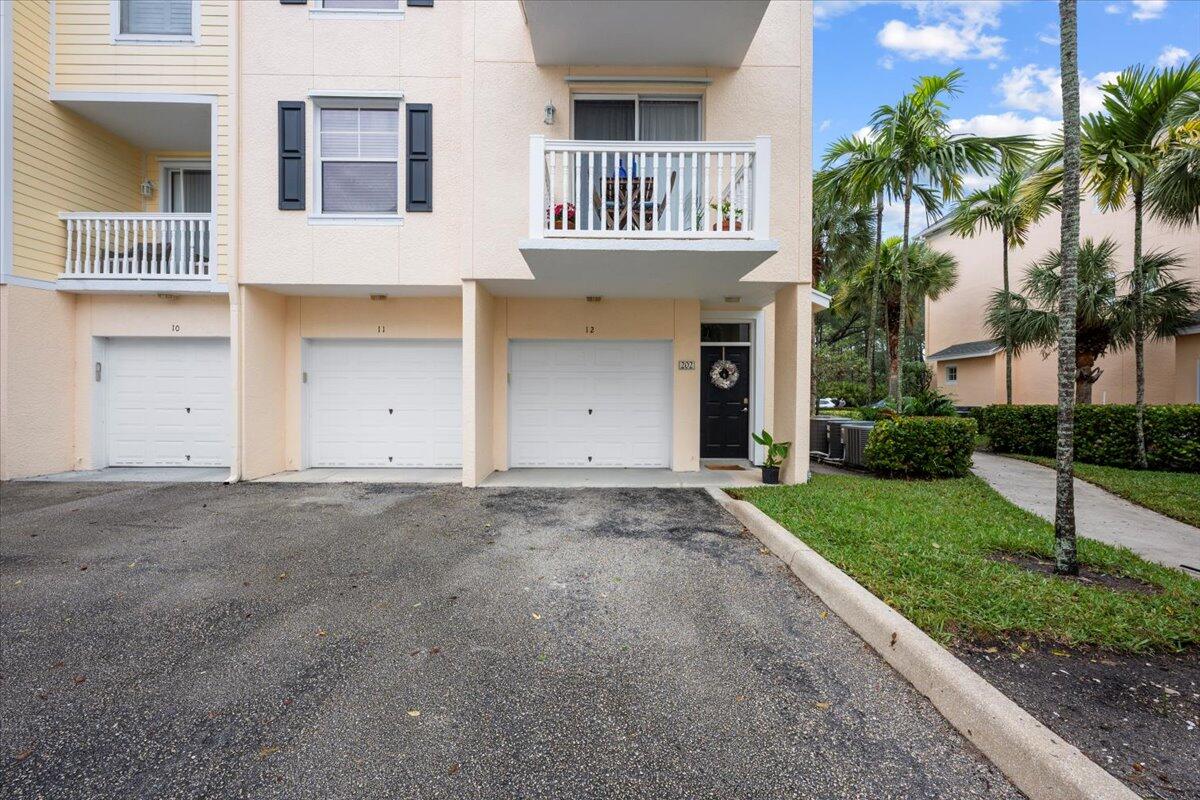 155 Galicia Way, Unit 202 Jupiter, FL 33458 - Photo 1 of 30 a house view with a garden space