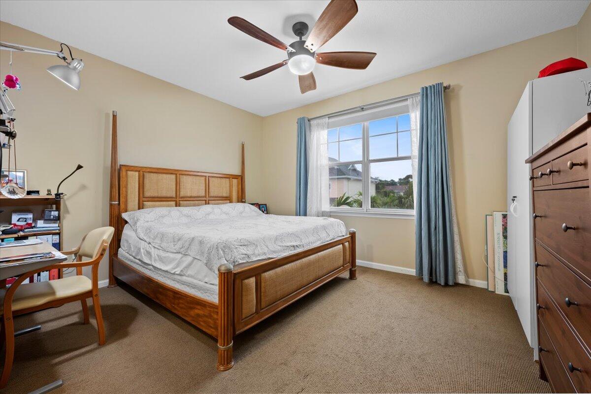 155 Galicia Way, Unit 202 Jupiter, FL 33458 - Photo 14 of 30 a bed sitting in a room next to a window