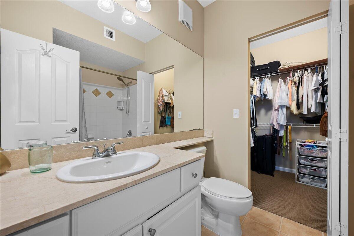 155 Galicia Way, Unit 202 Jupiter, FL 33458 - Photo 17 of 30 a bathroom with a sink toilet and shower