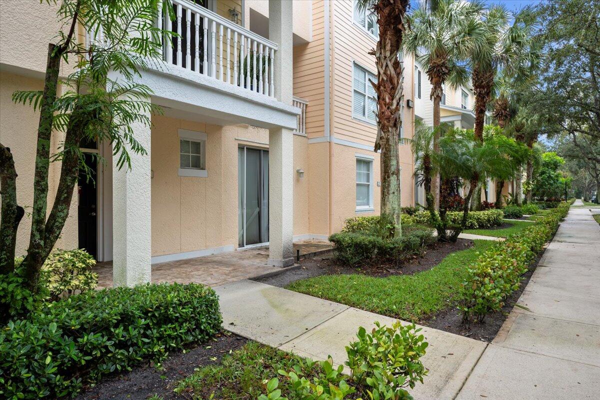155 Galicia Way, Unit 202 Jupiter, FL 33458 - Photo 22 of 30 a front view of a house with a yard