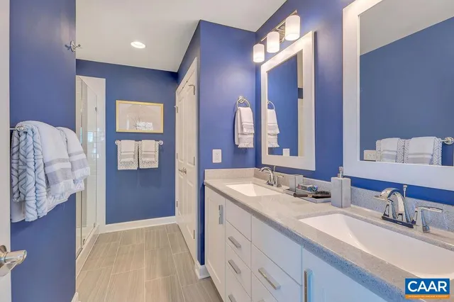 a spacious bathroom with a double vanity sink and a mirror