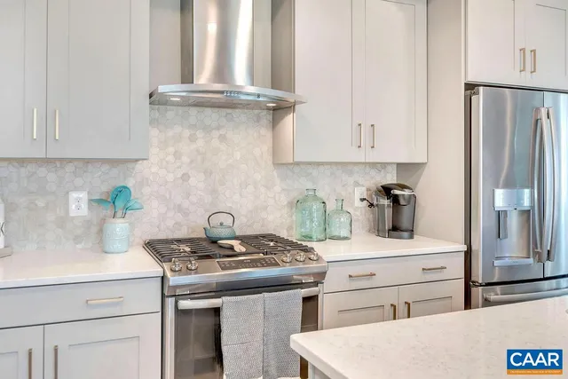 a kitchen with appliances a sink and cabinets