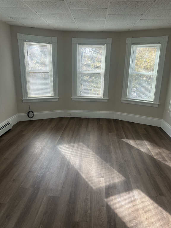17 Abington Street, Unit 3 Worcester, MA 01603 - Photo 12 of 23 an empty room with wooden floor and windows