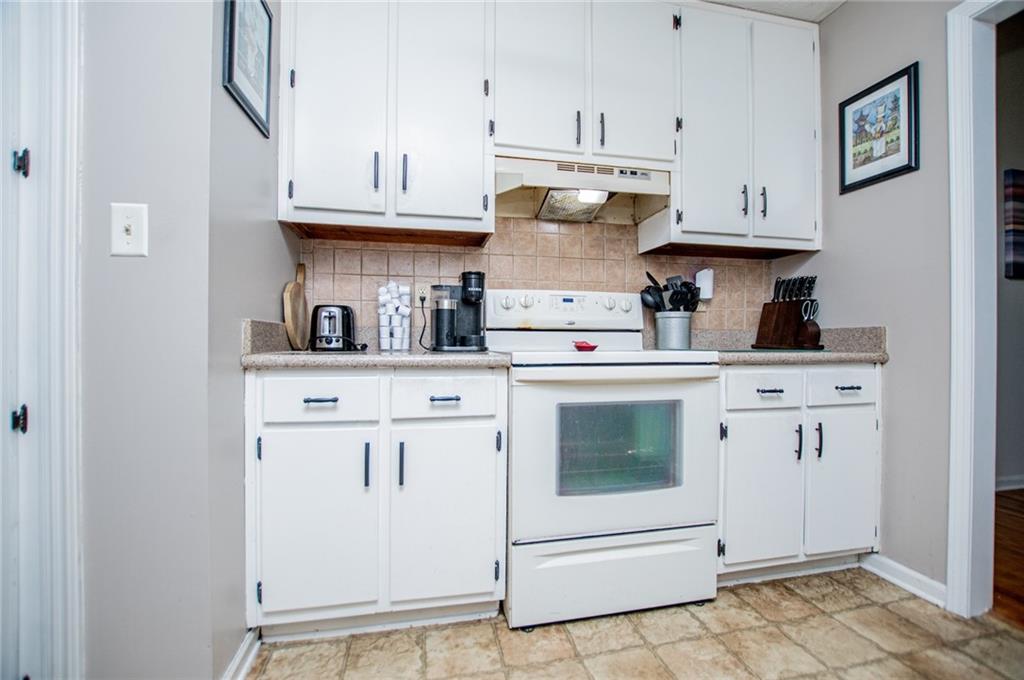 1385 Lakeview Parkway Villa Rica, GA 30180 - Photo 29 of 71 a kitchen with white cabinets and white appliances