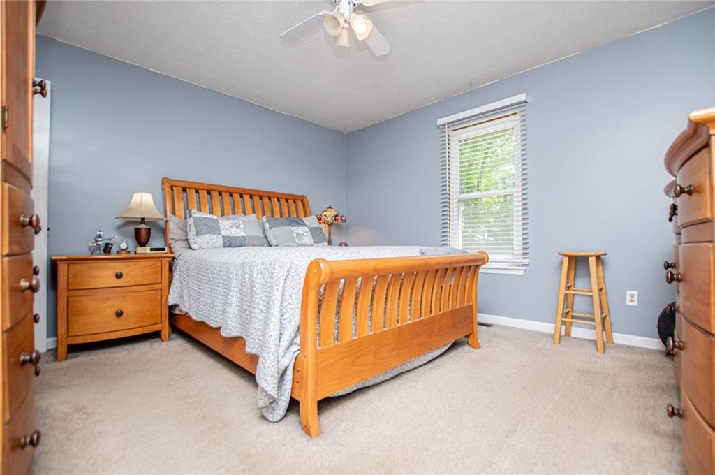1385 Lakeview Parkway Villa Rica, GA 30180 - Photo 37 of 71 a bedroom with a bed and a dresser