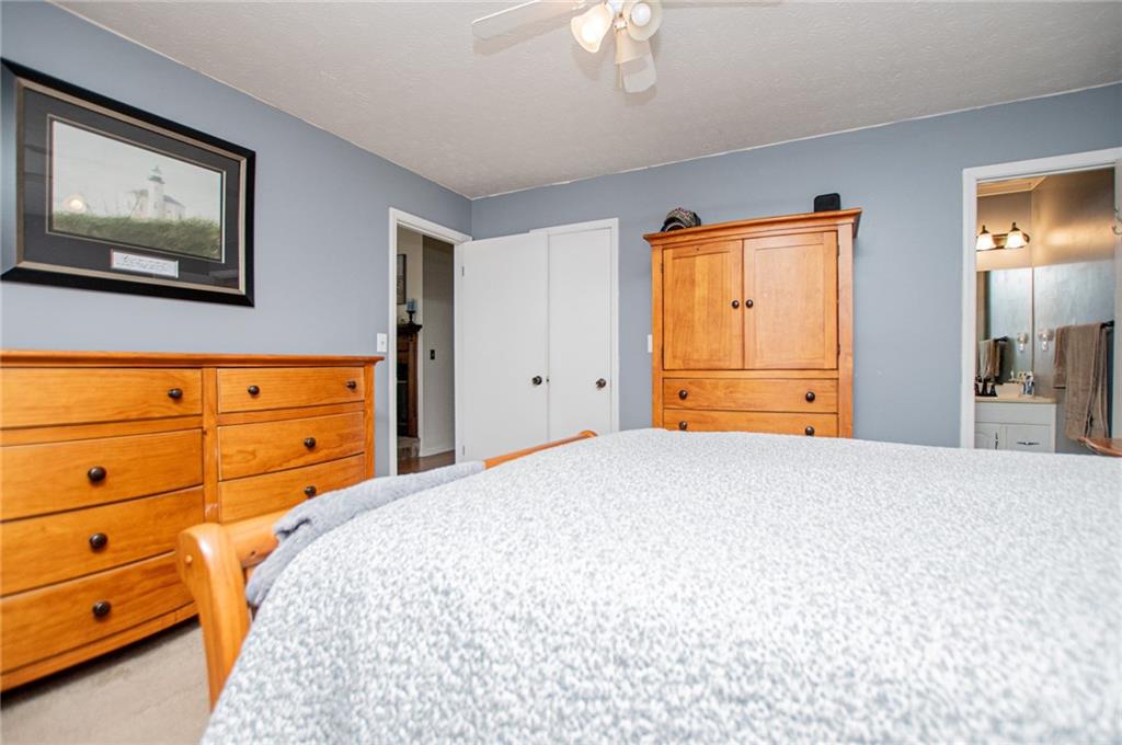1385 Lakeview Parkway Villa Rica, GA 30180 - Photo 39 of 71 a bedroom with a bed and a dresser