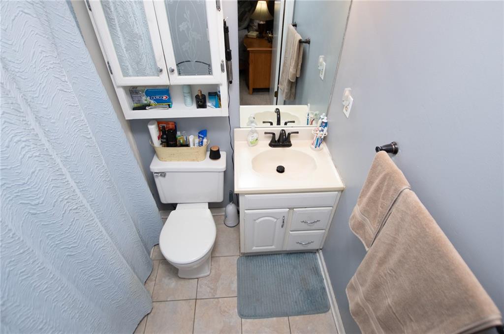1385 Lakeview Parkway Villa Rica, GA 30180 - Photo 42 of 71 a white toilet sitting next to a bathroom sink and a mirror