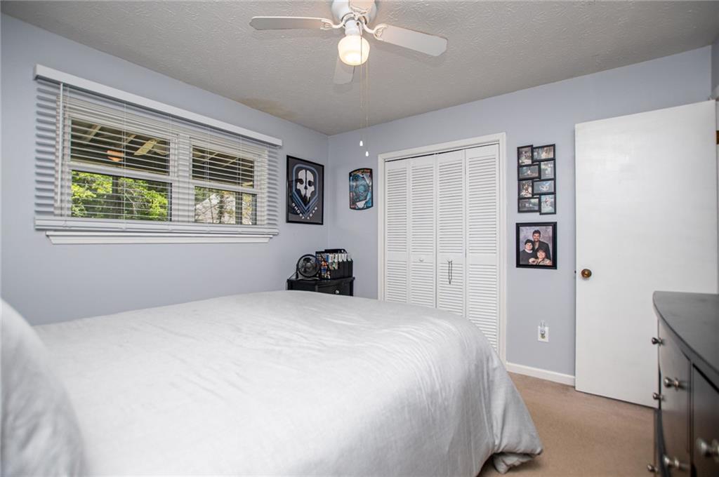 1385 Lakeview Parkway Villa Rica, GA 30180 - Photo 43 of 71 a bedroom with a large bed and a window