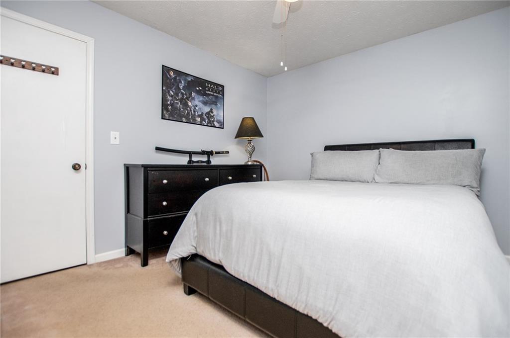 1385 Lakeview Parkway Villa Rica, GA 30180 - Photo 45 of 71 a bedroom with a bed and a cabinets