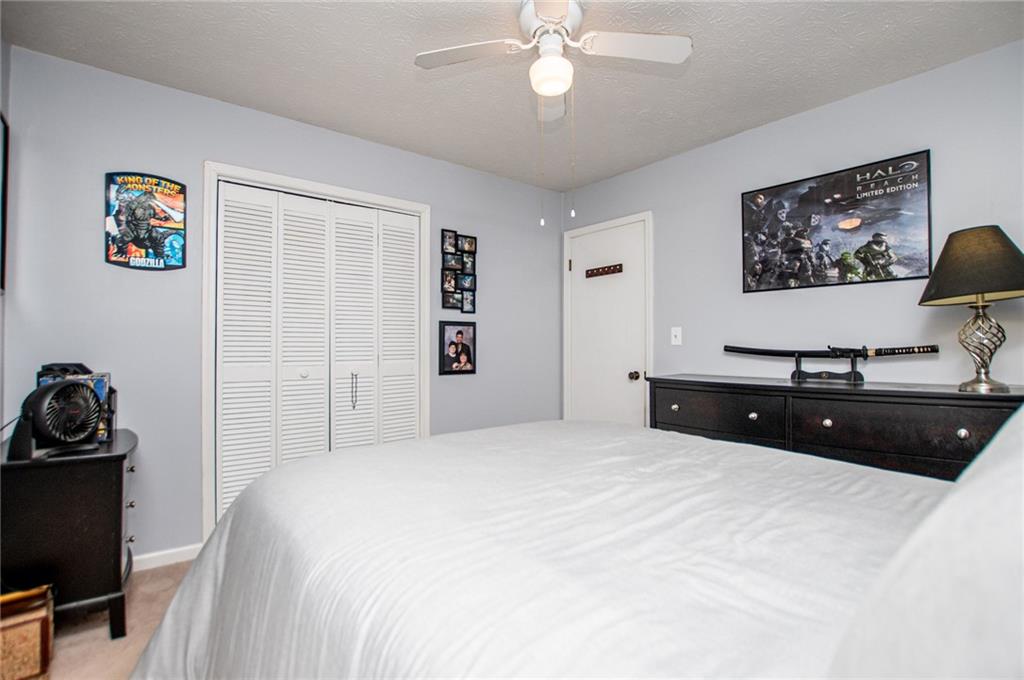 1385 Lakeview Parkway Villa Rica, GA 30180 - Photo 46 of 71 a bedroom with a bed and a flat screen tv