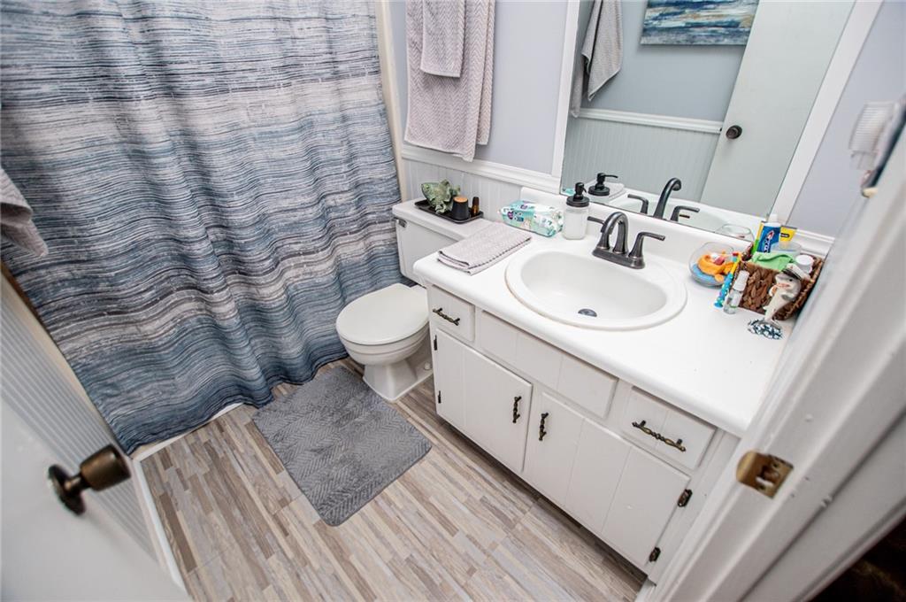 1385 Lakeview Parkway Villa Rica, GA 30180 - Photo 48 of 71 a bathroom with a sink a toilet and shower curtain