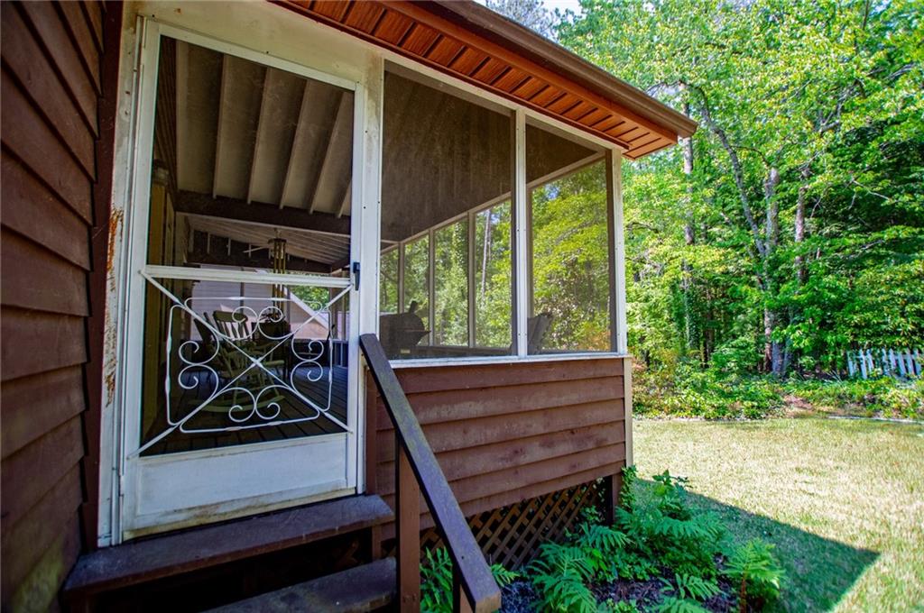 1385 Lakeview Parkway Villa Rica, GA 30180 - Photo 56 of 71 a view of a backyard with sitting area and porch with wooden floor