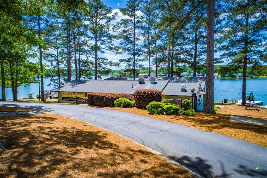 1385 Lakeview Parkway Villa Rica, GA 30180 - Photo 65 of 71 a tall yellow house with trees in front of it