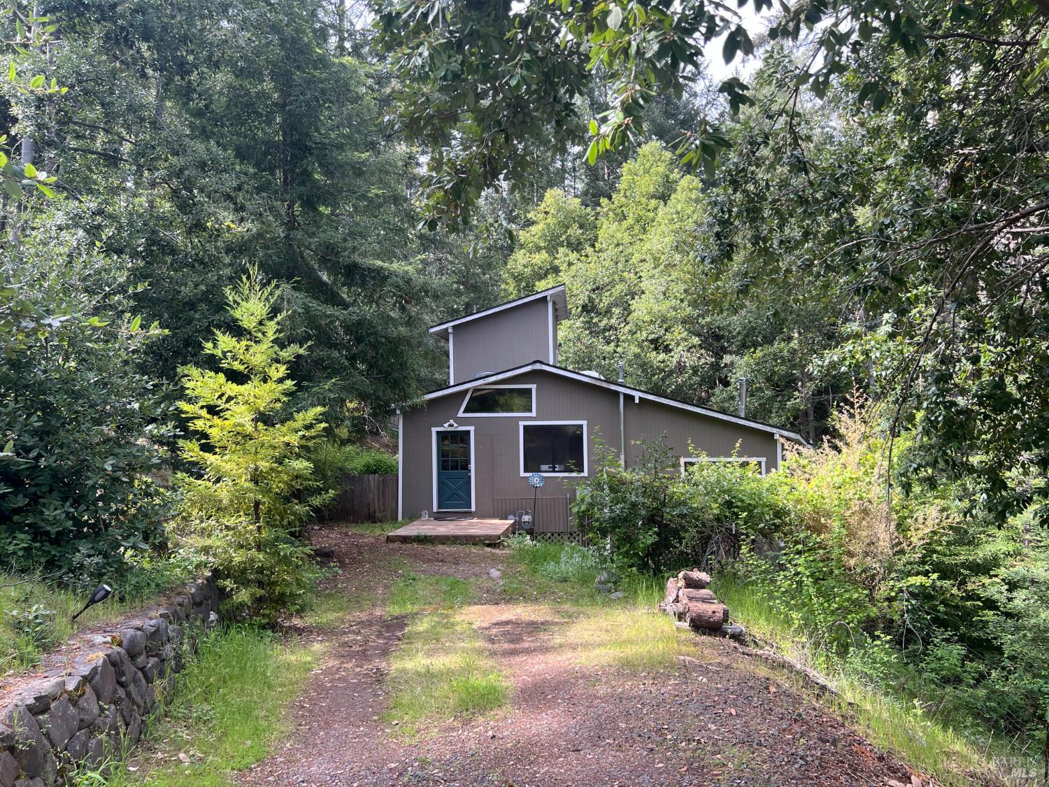 a view of a house with yard and sitting area