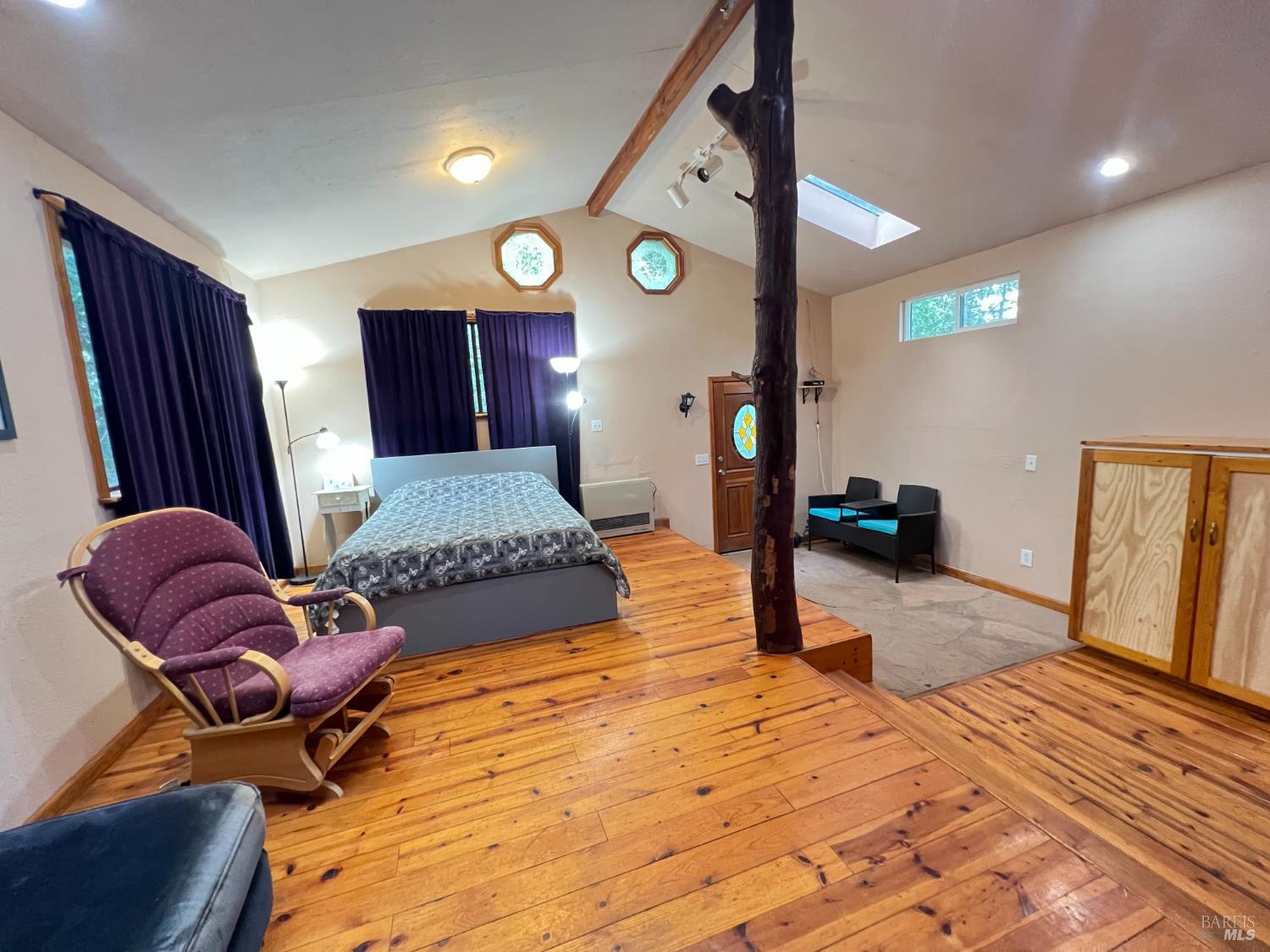 4000 Ridgewood Road Willits, CA 95490 - Photo 17 of 42 a bedroom with a bed and wooden floor