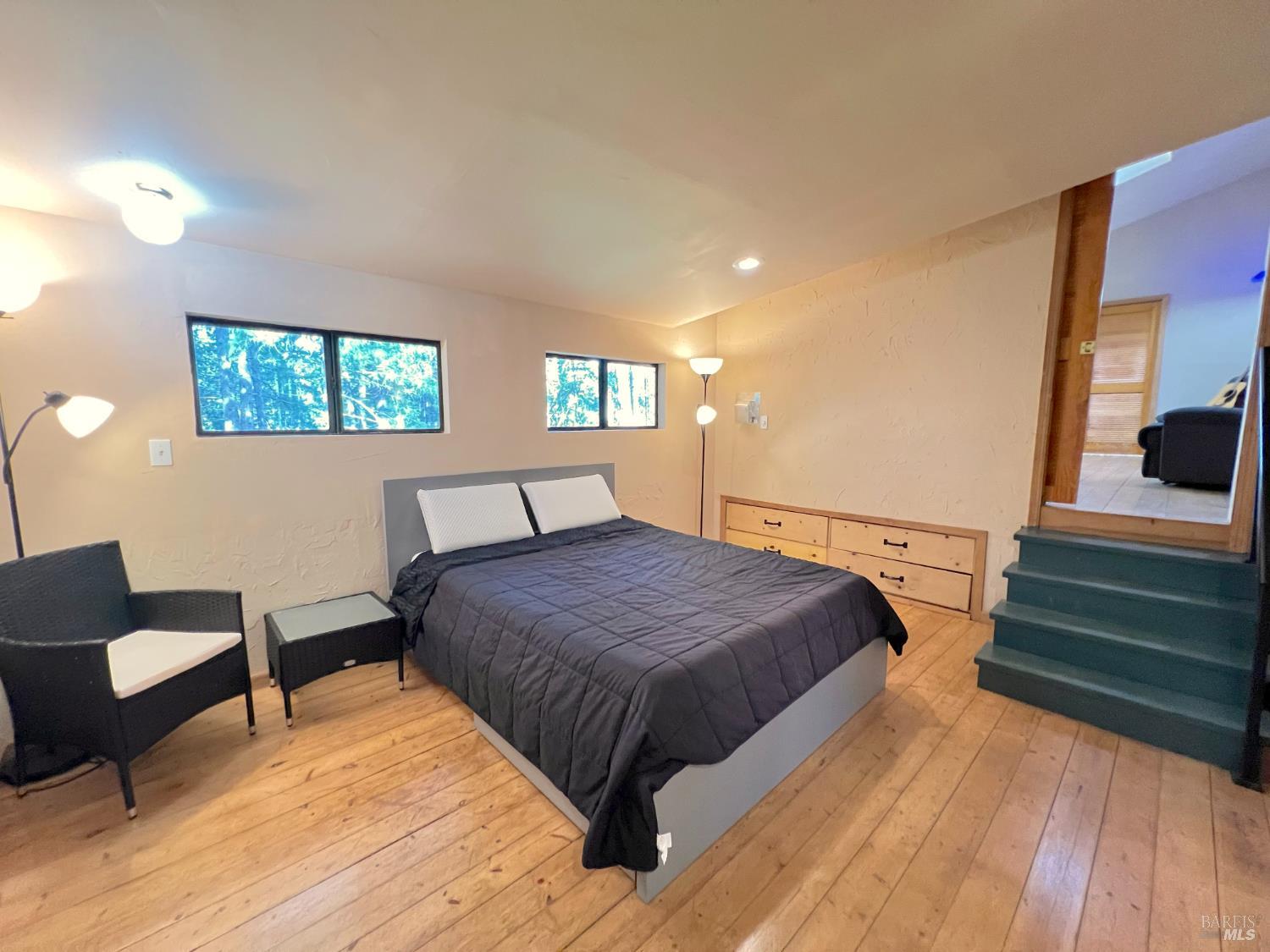 4000 Ridgewood Road Willits, CA 95490 - Photo 27 of 42 a bedroom with a bed and wooden floor