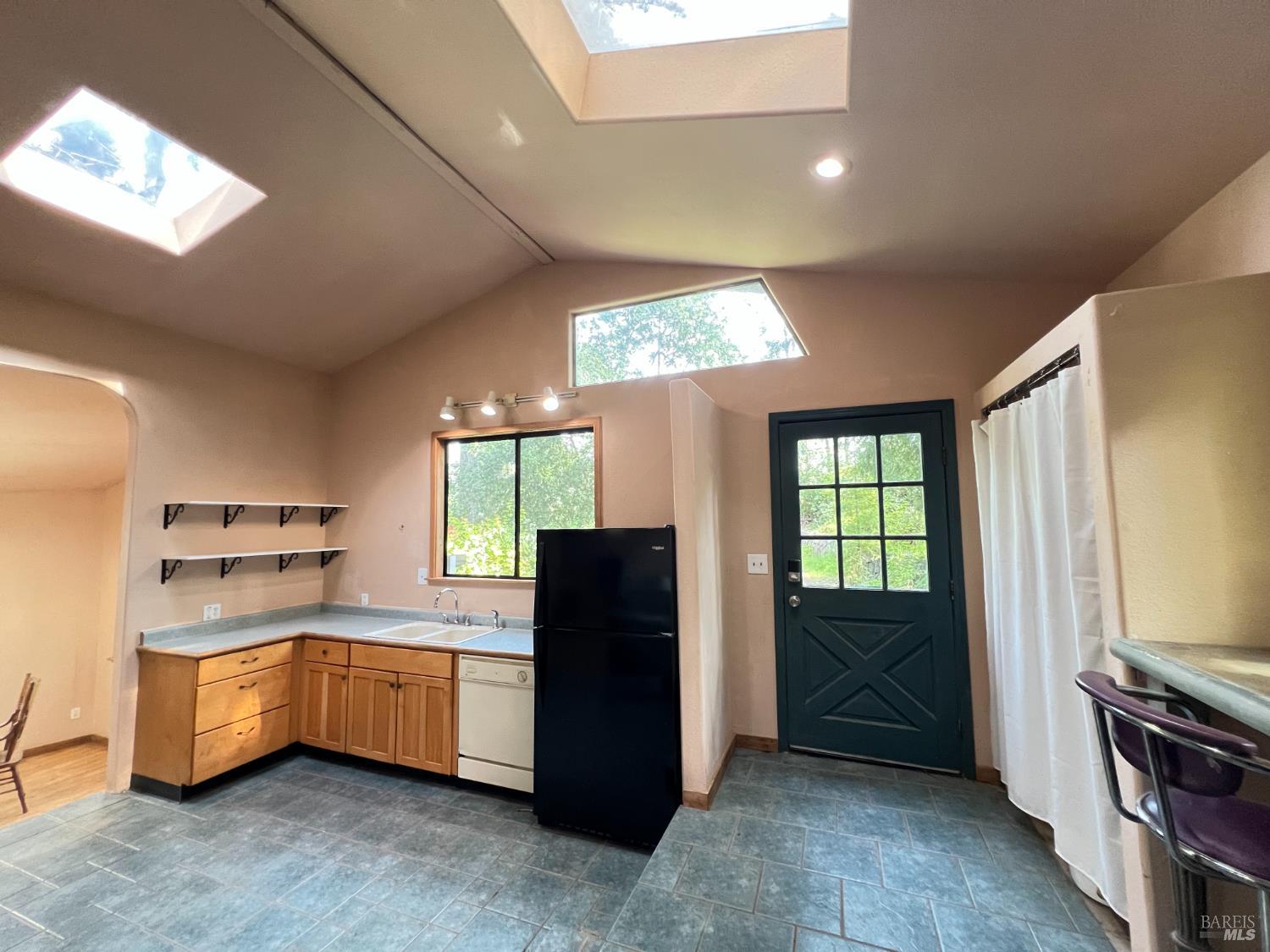 4000 Ridgewood Road Willits, CA 95490 - Photo 5 of 42 a kitchen with stainless steel appliances kitchen island granite countertop a refrigerator and a stove top oven