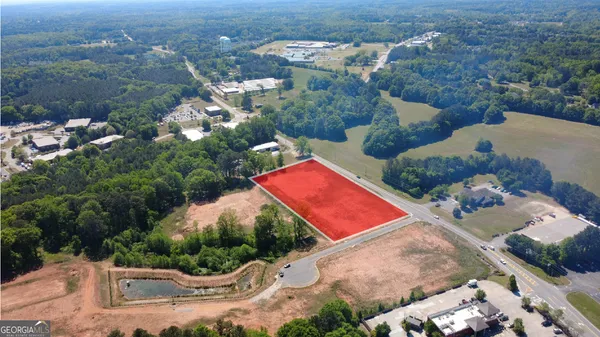 an aerial view of a house with yard