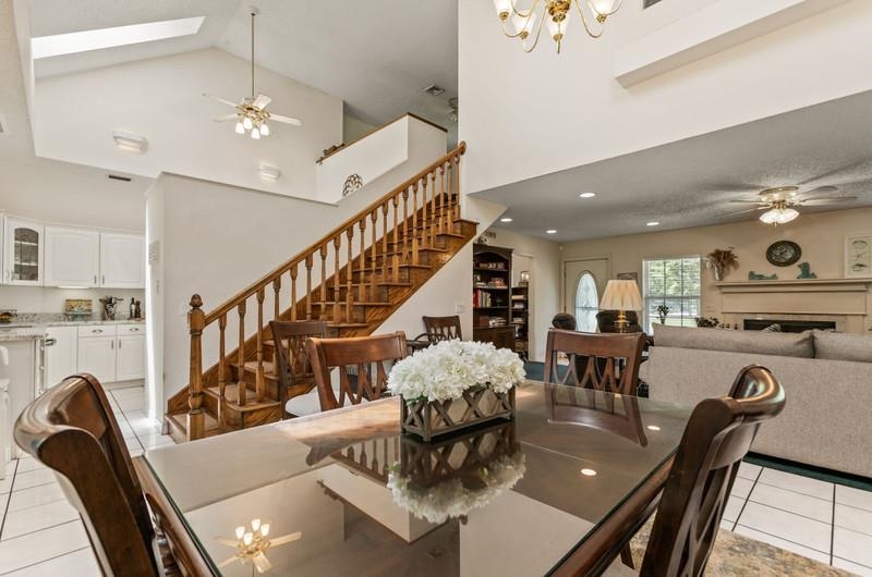 173 Stokes Landing Road St. Augustine, FL 32095 - Photo 11 of 71 a living room with couches chairs and a dining table with wooden floor