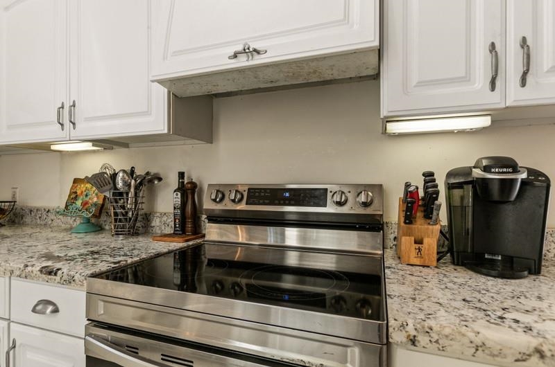 173 Stokes Landing Road St. Augustine, FL 32095 - Photo 13 of 71 a kitchen with white cabinets and appliances